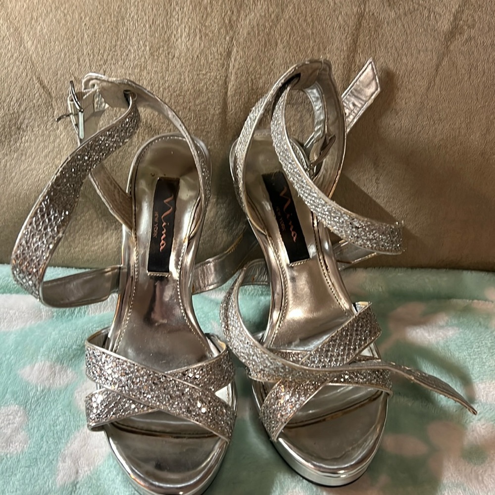 Silver heels with crisscross detail when on.